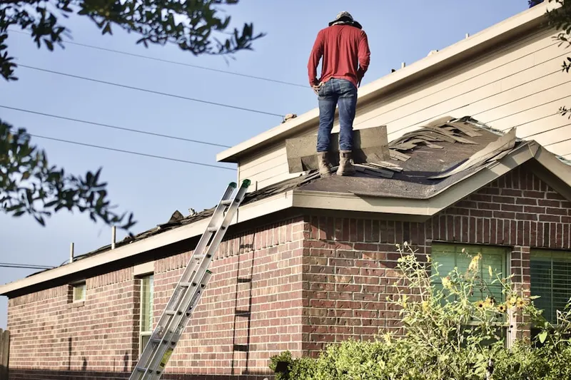 Professional roofer working on a residential roof in Cape Cod